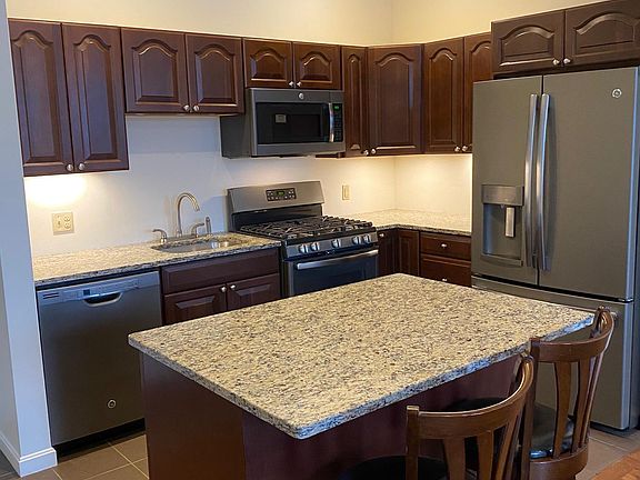 View of Kitchen with granite counter tops and stainless steel appliances.