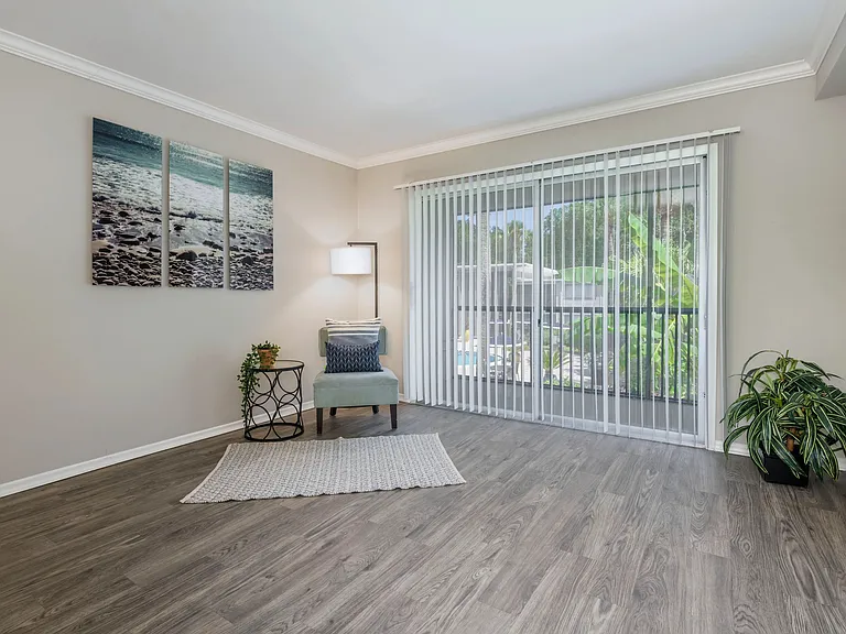 Immerse yourself in the enchantment of spacious living rooms adorned with warm wood-style flooring and inviting sliders that seamlessly connect to your private patio oasis - promising indoor-outdoor bliss.