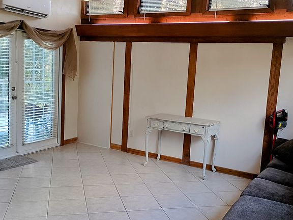 Stairs at the left side of the building lead to the spacious deck and the French door entry.