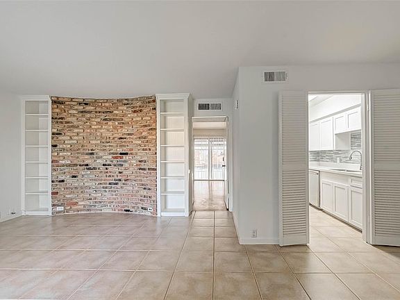 Views from the entry door into the living room, bedroom (center), and kitchen.