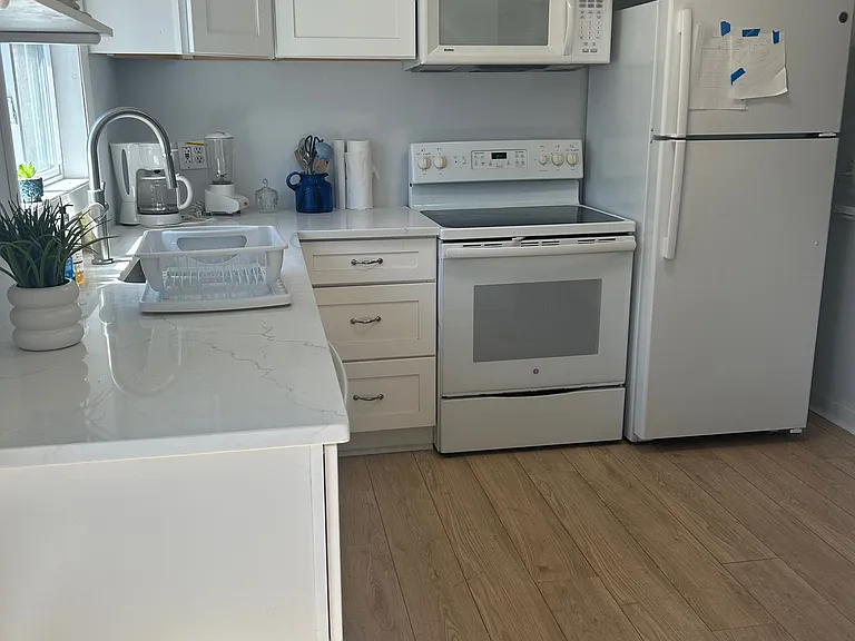 Kitchen with new counters and cabinets. Also with dishes, pots, pans, utensils, coffee maker, blender, mixer etc