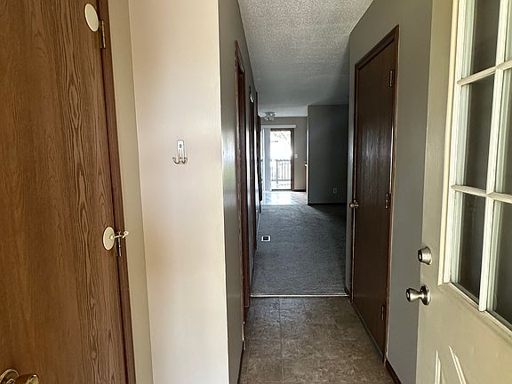 Entryway to the duplex with a closet for coats and jackets to the left.