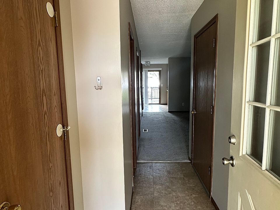 Entryway to the duplex with a closet for coats and jackets to the left.