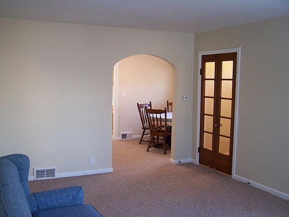 Spacious living room; graceful arched doorway leads into din