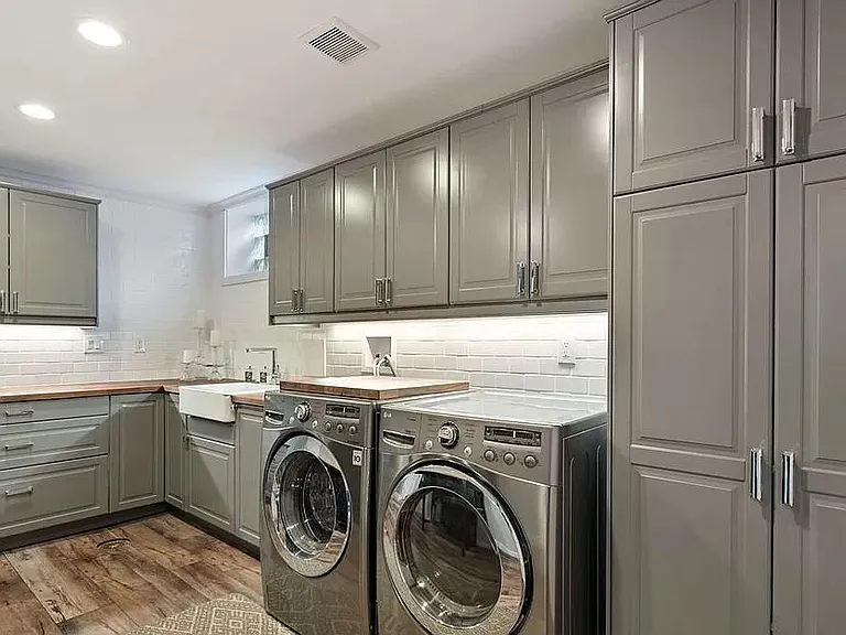 Laundry area with lots of counter space if you want to create a craft or workroom area