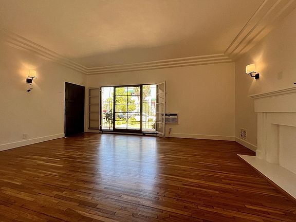 Living Room with french windows and mantle.