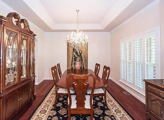 Again, you will see another sculptural element with the tray Ceiling  in the Dining Room and a view to the private cul de sac framed with the plantation shutters.  The owners have chosen a clean color palette to showcase the architecture of this residence