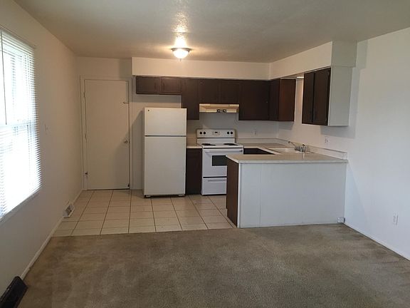 Kitchen, dining area and living room space.