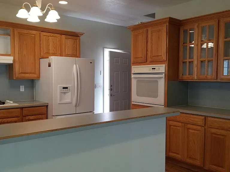 Another view of kitchen showing cabinets with glass doors.