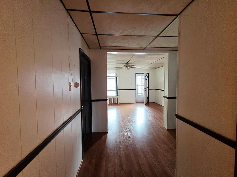 Halfway from the kitchen to the front door.
