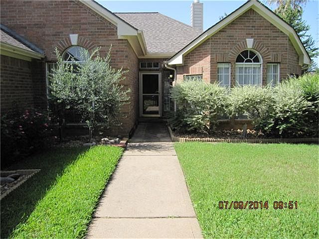 INVITING ENTRY WITH STORM DOOR PROTECTION.