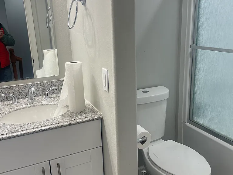 Bathtub with sliding glass door.