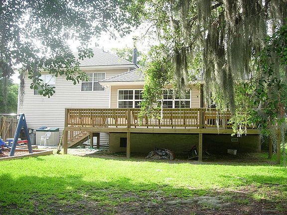 Back of house view. Scr. porch, wrap-around deck.