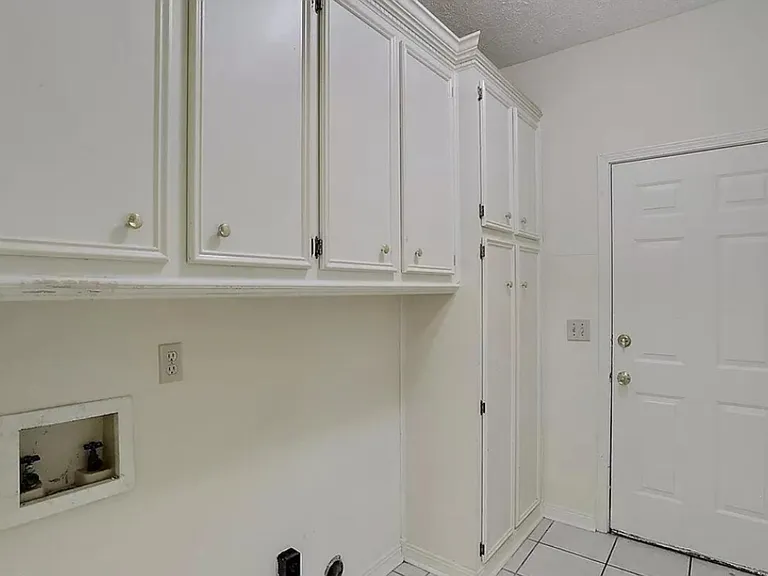 Laundry room, door to garage. Lots of cabinets