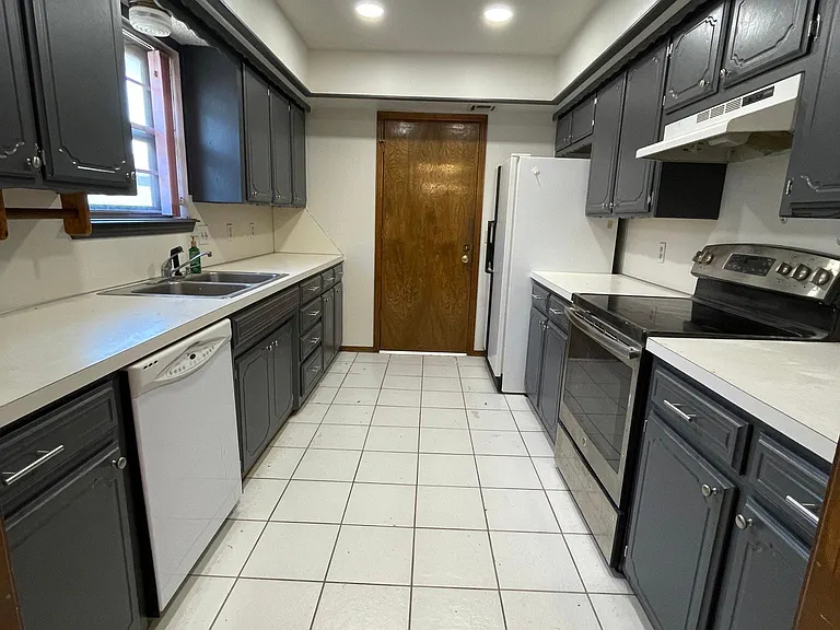 Kitchen with dishwasher, stove/oven and fridge