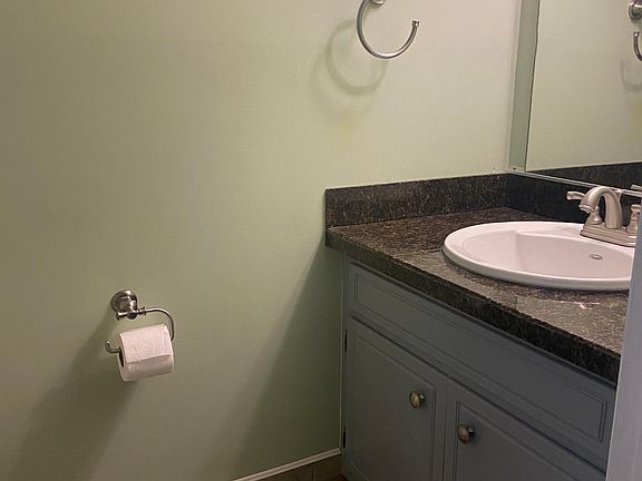 The half bath is located between the kitchen and living room