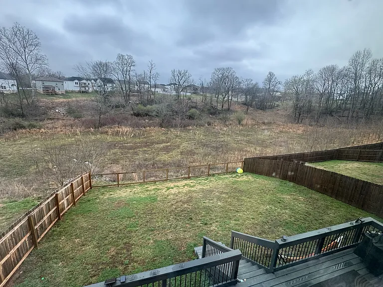 Backyard:
View of the extended and stained deck from the Primary Bedroom.