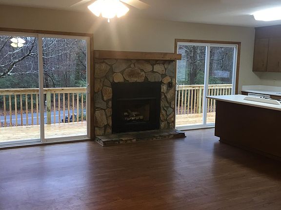 Open den/kitchen area with fireplace