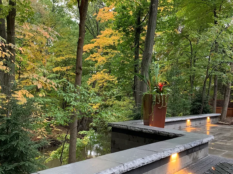 patio lighting at dusk with creek below