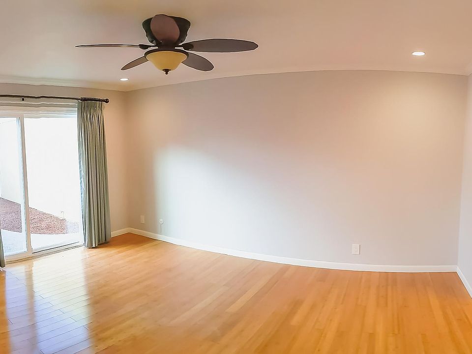 Master bedroom with ceiling fan, elegant curtains, recess lights, bamboo flooring, walking large closet with door