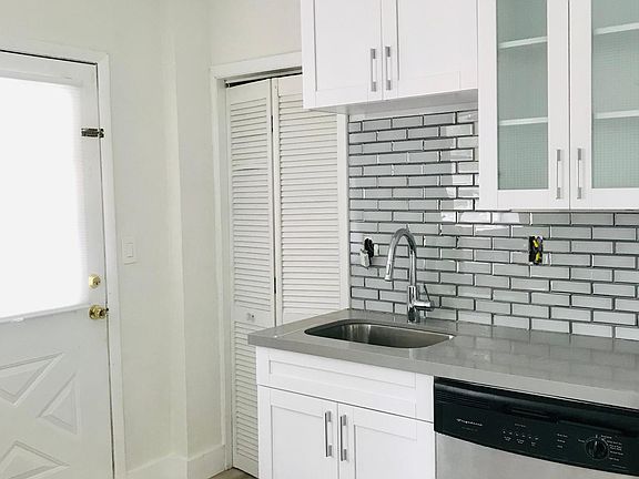 Kitchen and walk-in pantry. Door to yard.