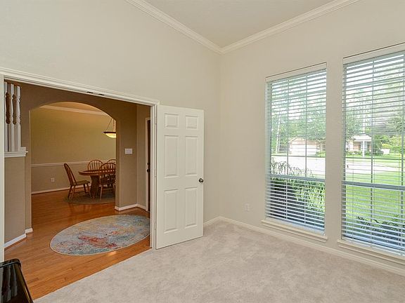 Private study has new carpet and fresh paint with views of the front yard.