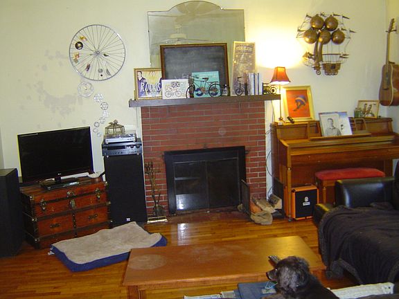 living room (looking west) fireplace has new wood burning in