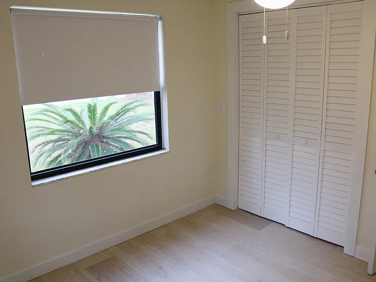 Privacy and peace. The second bedroom features a full closet, three windows and plenty of natural light.