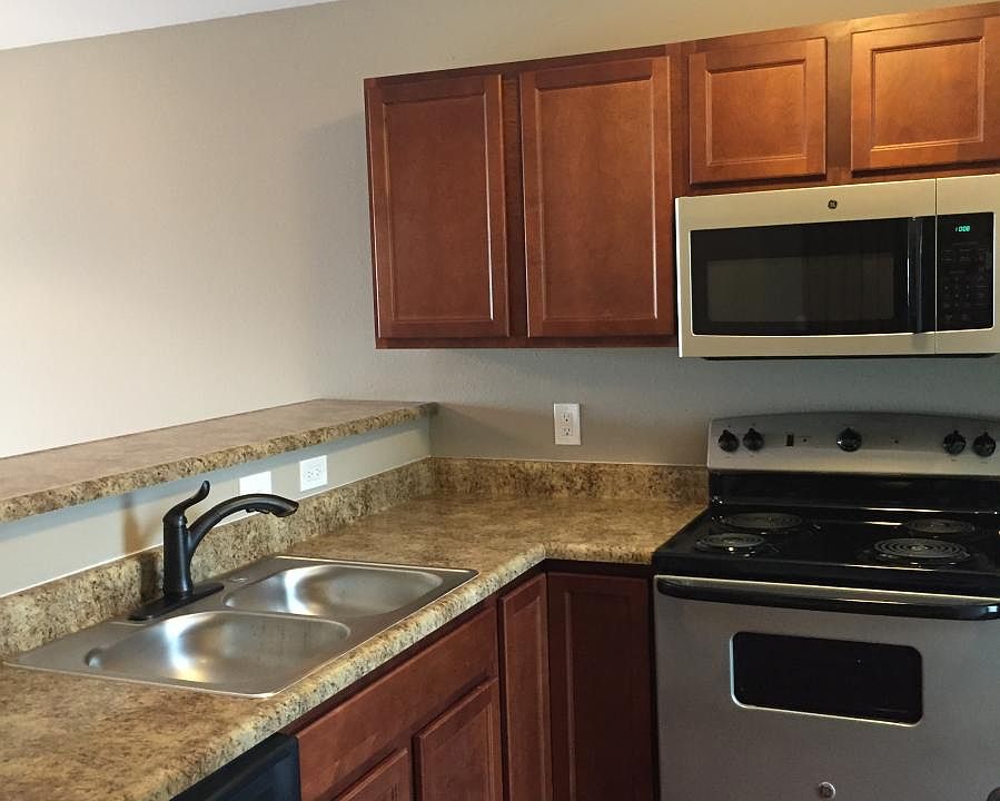 Kitchen with refrigerator, electric stove, microwave, and di