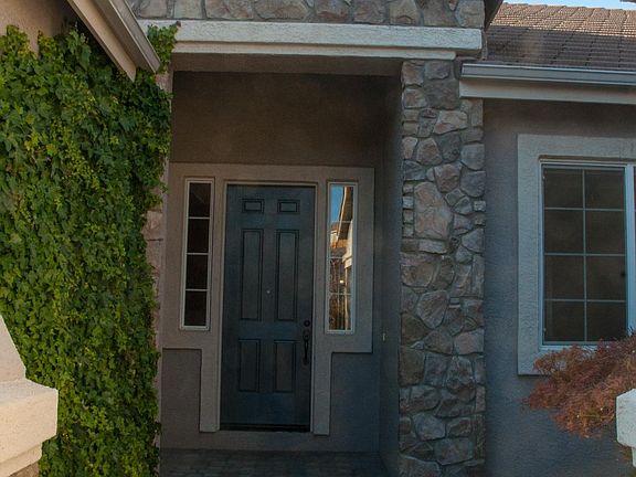 Grand front entry door with a small private courtyard