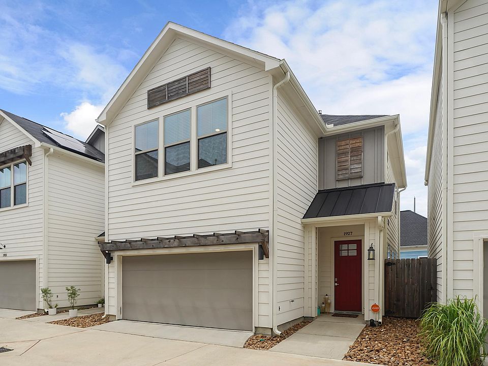 Exterior showing attached garage, small porch, and side entry gate