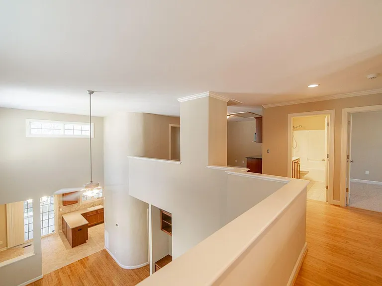 LOFT WITH VIEW OF LIVING, DINING, AND KITCHEN AREAS