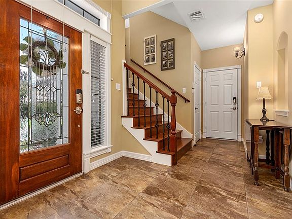 Greeted in a two story entryway with custom tile and decorative niches. You will appreciate all the closet space this home has to offer