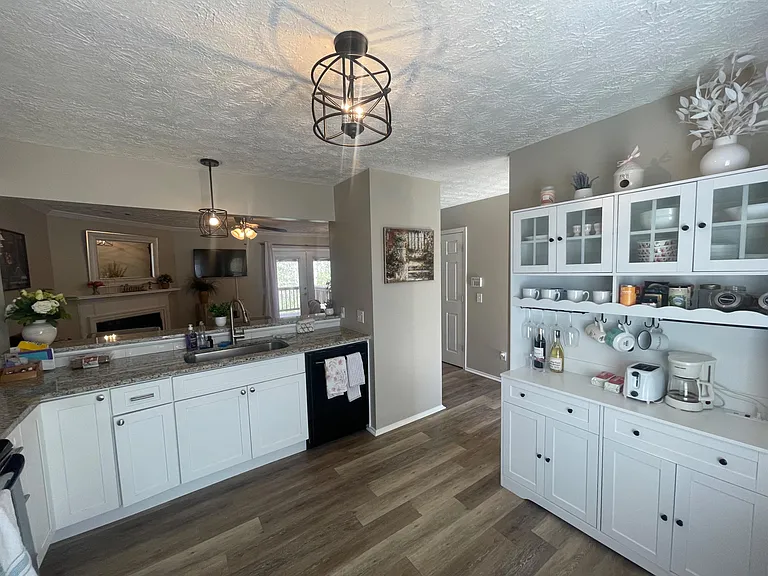 Open kitchen with ample counter space, breakfast bar seating, and generous cabinetry for everyday storage and prep.