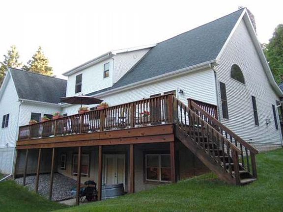 Sit on the open balcony deck and enjoy the back yard nature visitors.  The 10x42 deck can be accessed from the yard, the great room and the master suite.