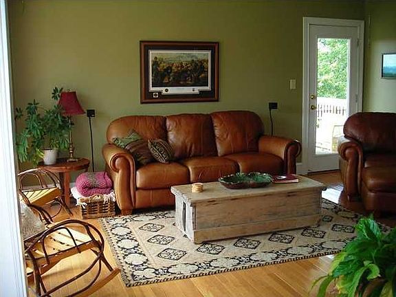 The living room features a large bay window and a side porch!