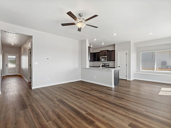 Open-concept layout, showcasing a large family room and upgraded kitchen.