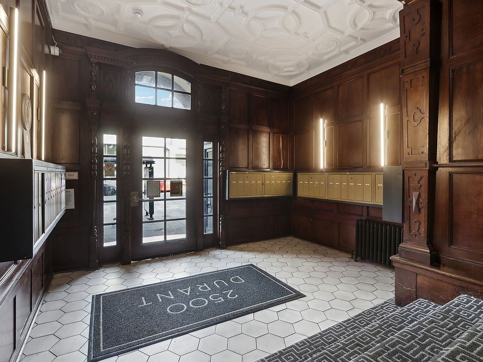 Grand entrance to a building, featuring a large wooden door with a glass window