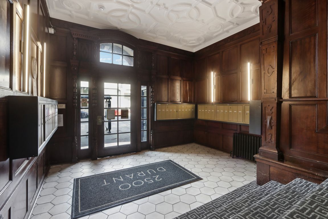 Grand entrance to a building, featuring a large wooden door with a glass window