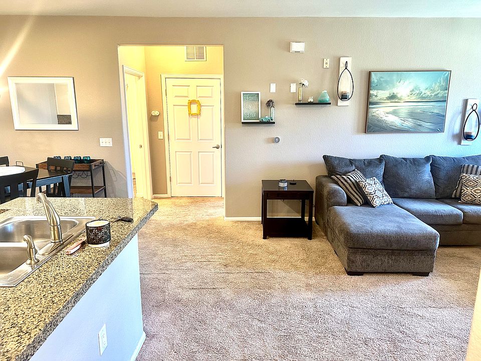 Upon entering your private 2nd story condo, your entertainment and lounge area is on the right with a private patio and the granite countered open kitchen on your left