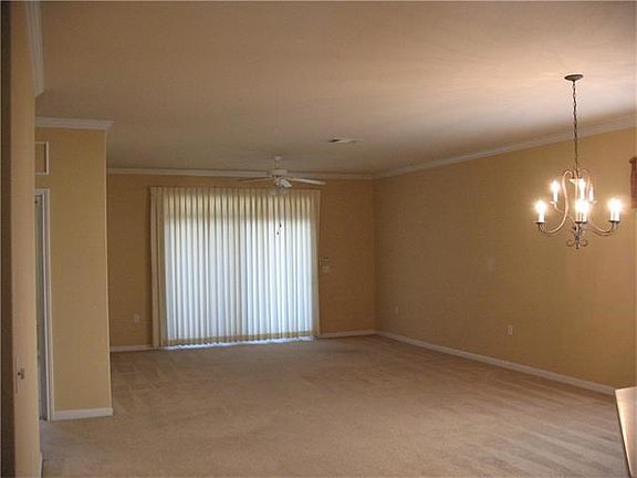 FAMILY ROOM WITH CROWN MOLDING COMBINES WITH DINNING TO MAKE THIS A WINNING ARRANGEMENT.
