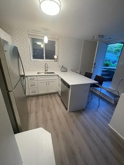 View of front door and kitchen