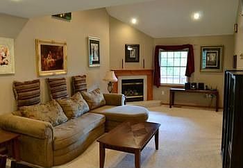 Another living room view from the dining room area highlights the gas fireplace and neutral wall colors.