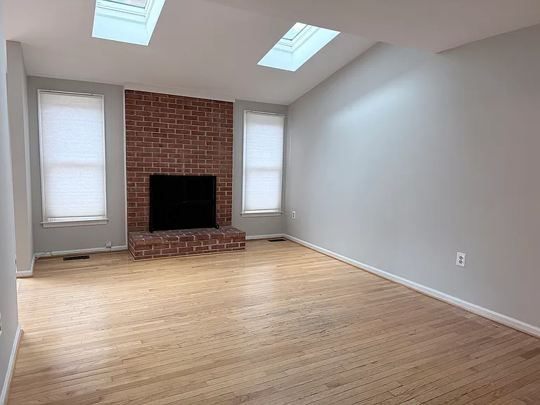 Family room with wood fireplace and skylights