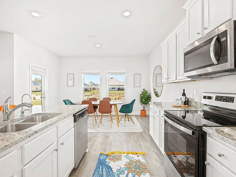 Open kitchen to living space with indoor seating for 10.