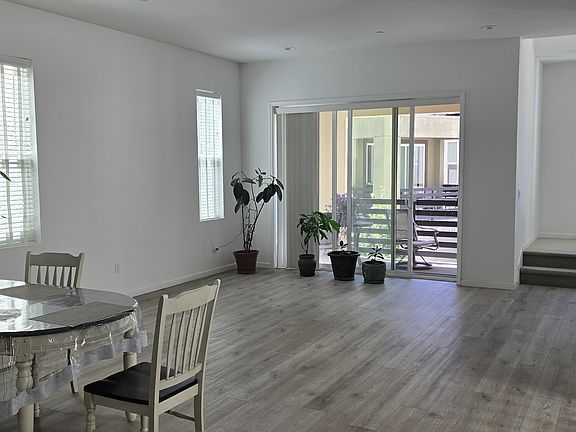 Spacious family room with an adjacent dining area and kitchen, perfect for family gatherings.