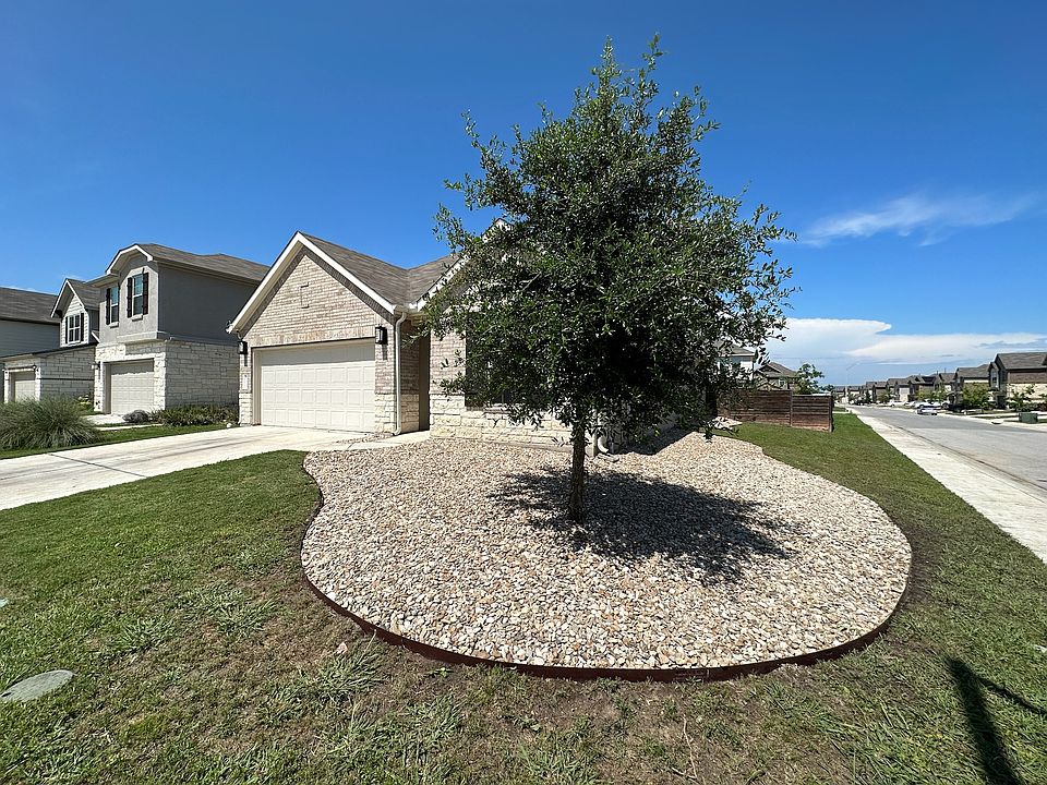 Xeriscaped front yard, driveway to 2 car garage