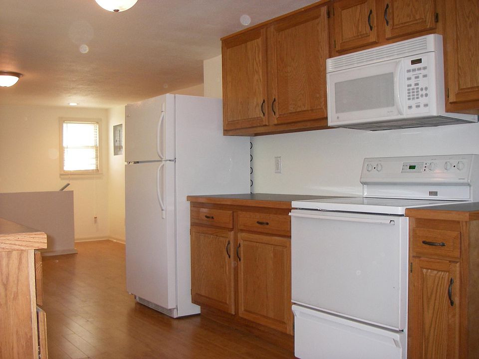 Older picture of kitchen with walls painted off-white.