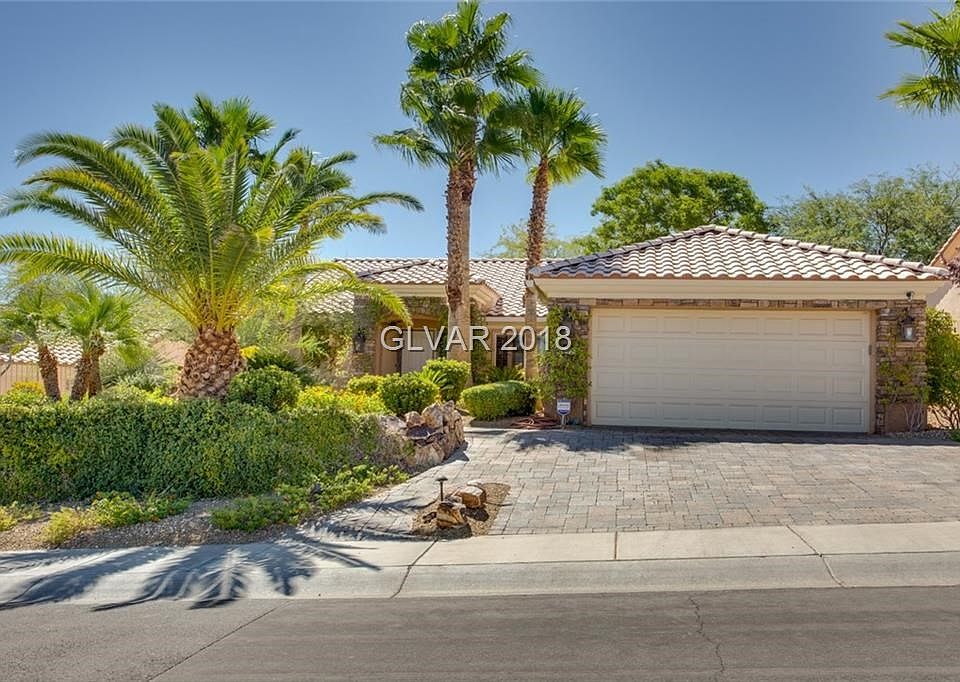 WOW!  CURB APPEAL !!!!   Exterior Front boasts brick paver driveway and walkway, lush landscaping with several palms trees.  Hom