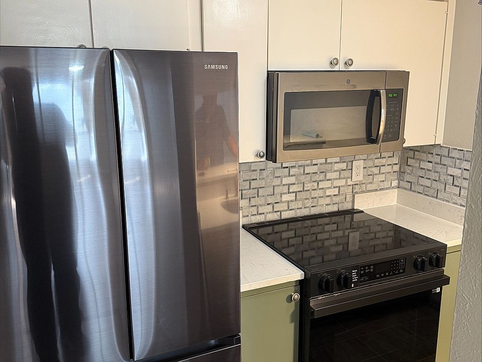Remodeled kitchen with new appliances and custom backsplash.